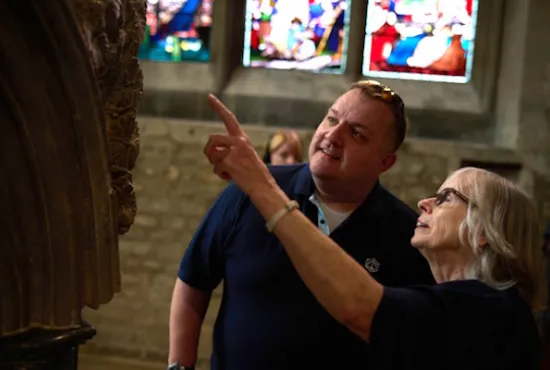 A cathedral guide describing a feature to a visitor
