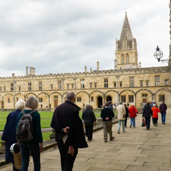 Parish Pilgrims cross Tom Quad towards the cathedral, whose spire is visible in the background