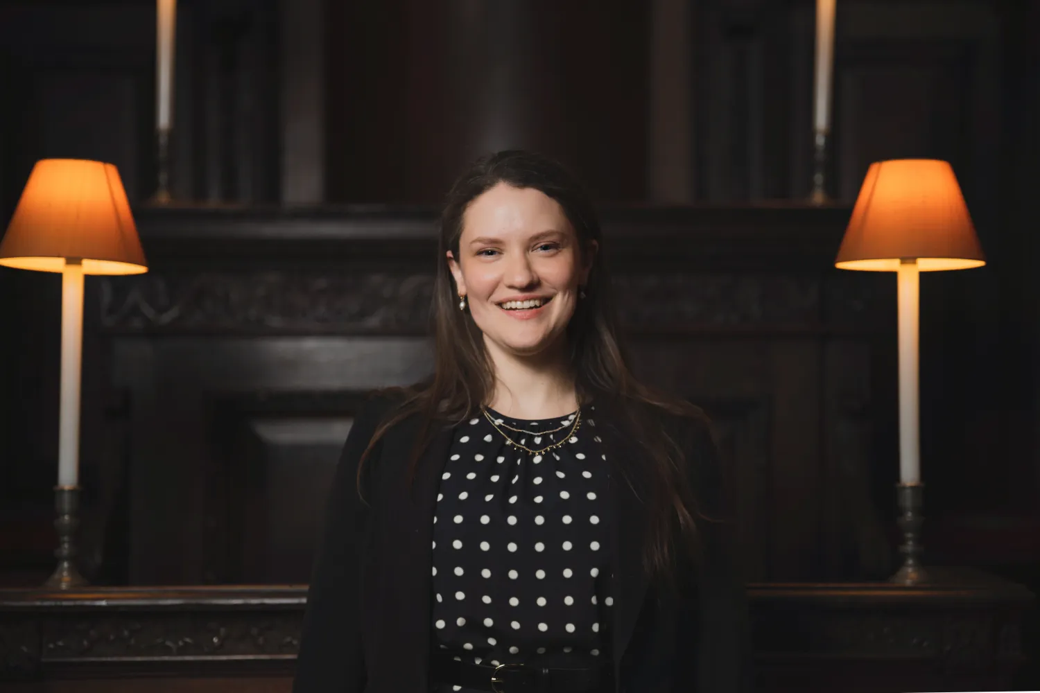Hilary Punnett sits in the Choir of St Paul's cathedral, a dark wooden stall between two lanterns.