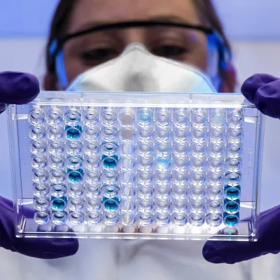 A biochemist inspecting some vials